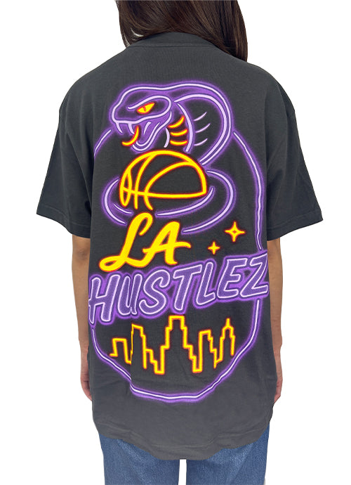 Person wearing a black t-shirt with a neon-style graphic design on the back.